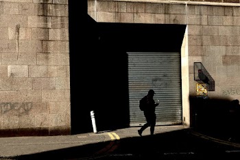 Photo of Person Walking on Pavement