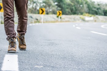 Photo of Person Walking on Road