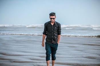Photo of Person Walking On Seashore