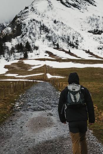 Photo of Person Walking on Unpaved Pathway