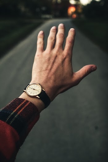 Photo of Person Wearing Analog Watch