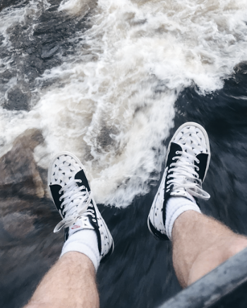 Photo of Person Wearing Black And White Sneakers
