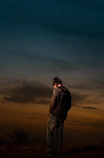 Photo of Person Wearing Gray Pullover and Blue Faded Jeans