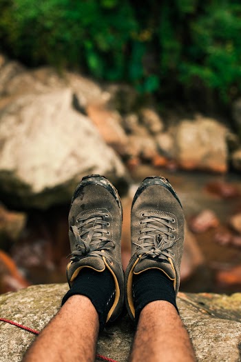 Photo of Person Wearing Gray Sneakers