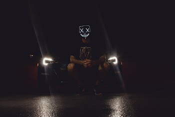 Photo of Person Wearing Mask While in Front of Vehicle