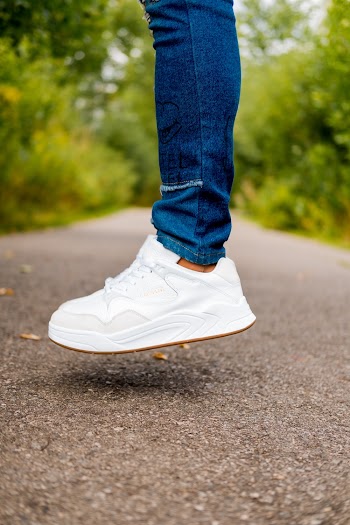 Photo of Person Wearing White Shoes