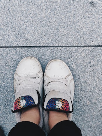 Photo of Person Wearing White Shoes