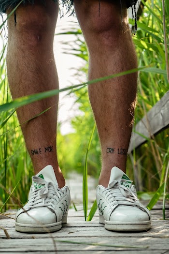 Photo of Person Wearing White Sneakers