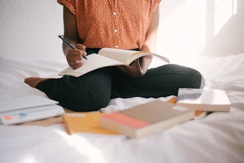 Photo Of Person Writing On Notebook