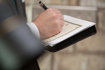 Photo of Person Writing on Paper