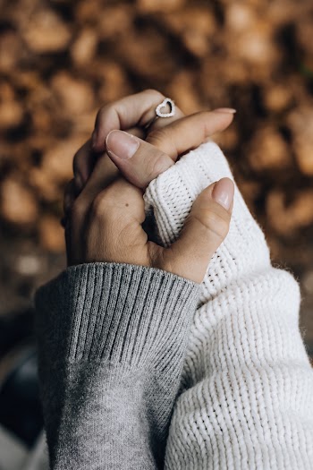 Photo of Persons Holding Hands