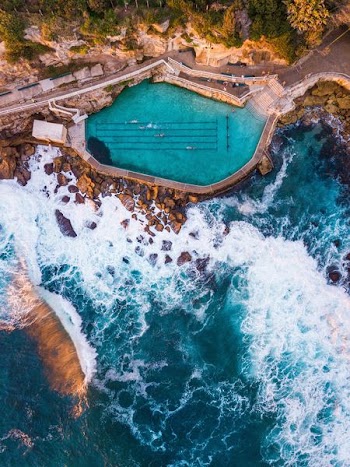 photo of pool near body of water