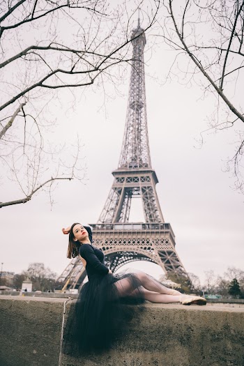Photo of Posing Ballerina on Concrete Block With The Eiffel Tower in the Background