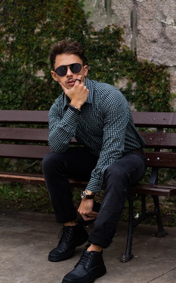 Photo of Posing Man Sitting on Wooden Park Bench