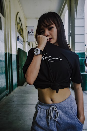 Photo of Posing Woman in Black Shirt and Grey Bottoms