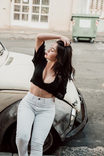 Photo of Posing Woman Leaning on Old VW Bettle