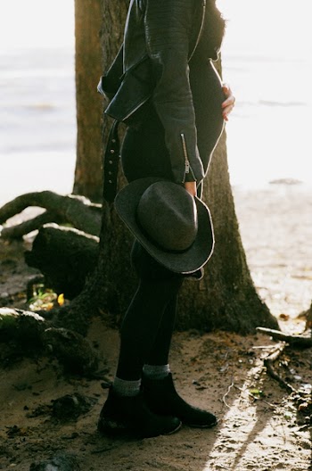 Photo of Pregnant Woman Standing Behind the Tree