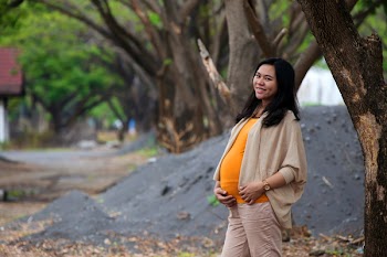 Photo of Pregnant Woman Standing Near Tree
