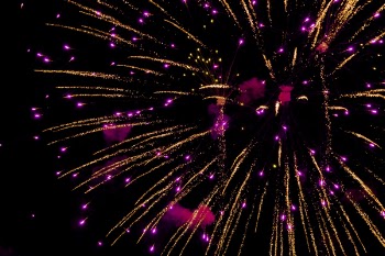 Photo of Purple and Yellow Fireworks in Night Sky