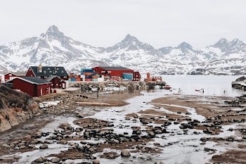 photo of red and black houses near mountains