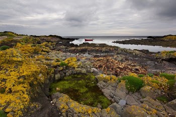 photo of red boat on body of water