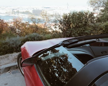 Photo Of Red Car Near Curb