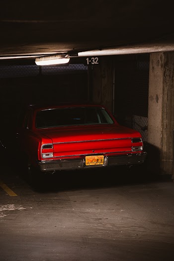 Photo of Red Muscle Car Parked in Underground Parking Spot