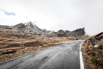 photo of road across mountain during daytime