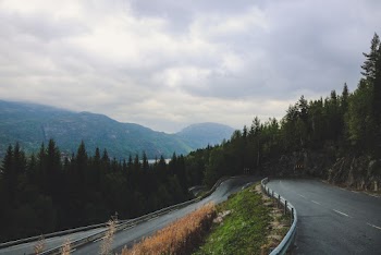 Photo of Roadway Under Cloudy Sky