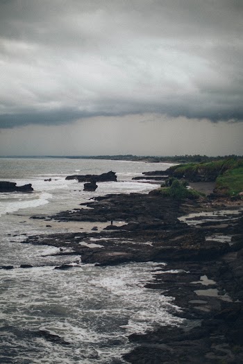 Photo of Rocky Shore Under cloudy Sky