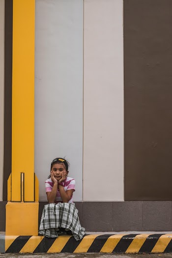 Photo of Sad Young Girl Sitting Alone by Curb