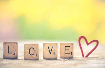 Photo of Scrabble Letter Tiles Forming the Word Love.