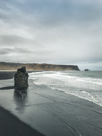 Photo of Seashore Under Cloudy Sky