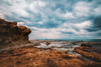 Photo of Seashore Under Cloudy Sky