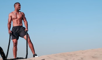Photo of Shirtless Man Holding Rope