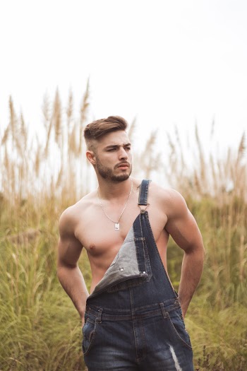 Photo of Shirtless Man in Blue Denim Dungarees 