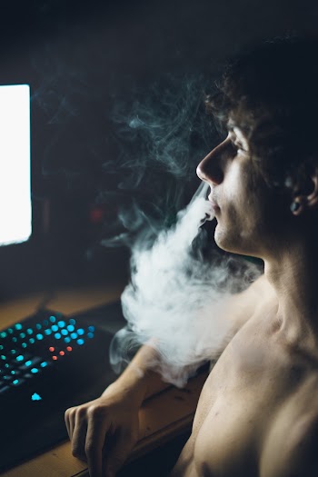 Photo of Shirtless Man Smoking