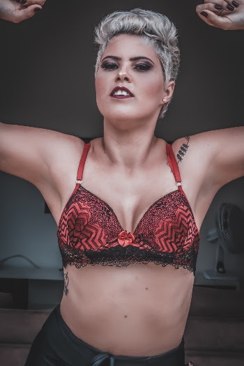 Photo of Shirtless Woman in Black and Red Bra Posing
