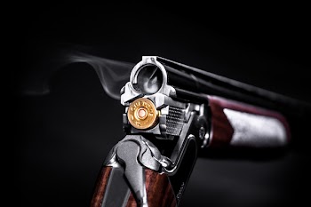Photo of Silver and Brown Flintlock Pistol With Brass Ammo