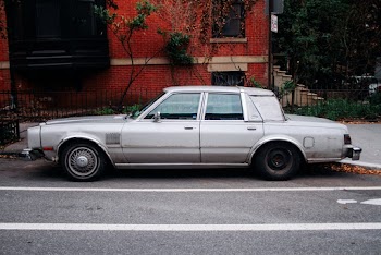 Photo of Silver Sedan Parked Near Red Building