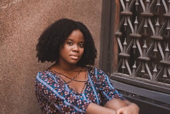 Photo of Sitting Woman in Floral Top Posing