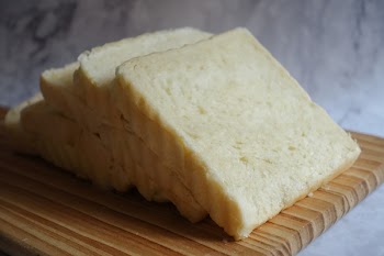 Photo of Sliced Bread on Brown Wooden Chopping Board