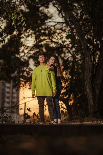 Photo of Smiling Couple Standing Under a Tree