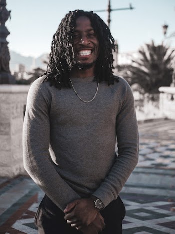 Photo of Smiling Man in Gray Long-sleeved Sweater