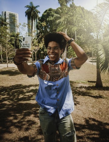 Photo of Smiling Man Taking a Selfie With Palm Trees in the Background