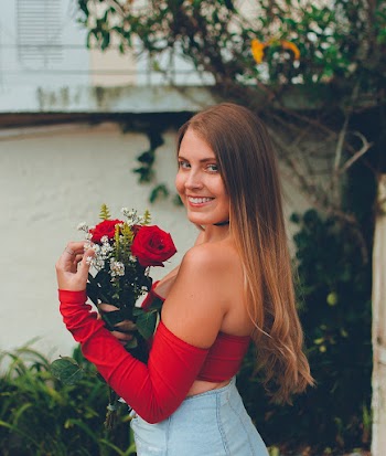 Photo of Smiling Woman Carrying Roses