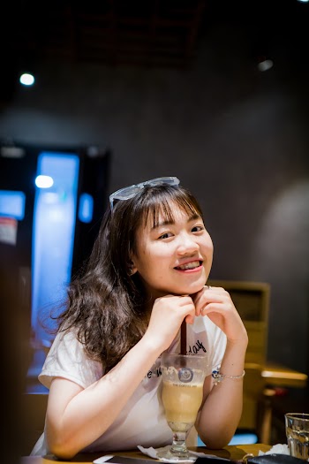 Photo of Smiling Woman Having a Drink