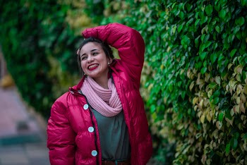 Photo of Smiling Woman Holding Her Hair