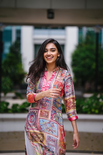 Photo of Smiling Woman In Floral Salwar Kameez Posing
