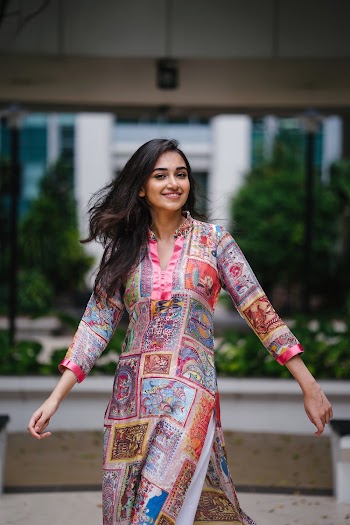 Photo of Smiling Woman In Floral Salwar Kameez Posing